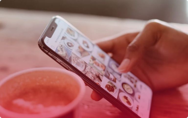 Hand holding phone with pictures of coffee