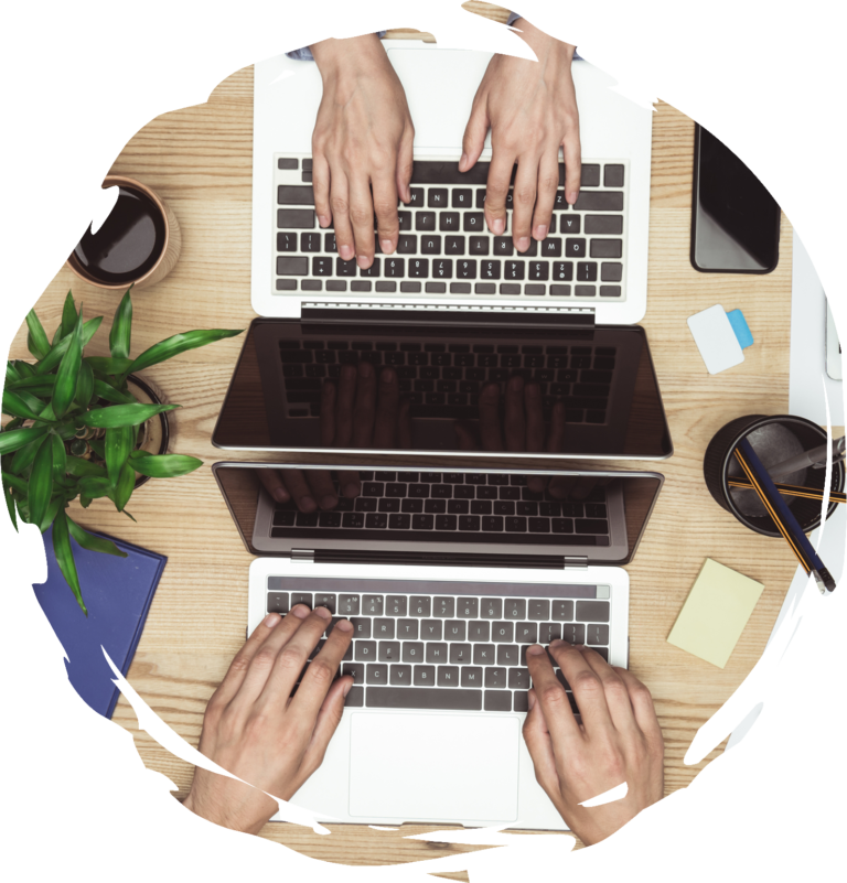 Two back to back laptops being typed on