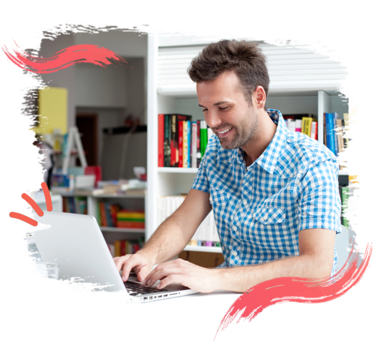 Photo of a man typing on a laptop